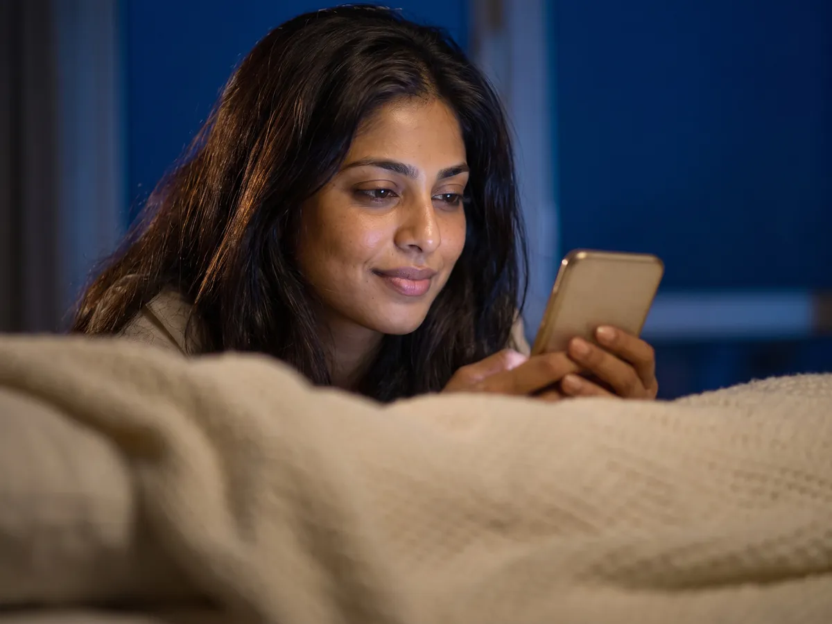 Fine Lines and Wrinkles Treatment in Jaipur: Poor sleep: the client awake in bed at night, phone glow on her face | AI Aesthetics, C-Scheme
